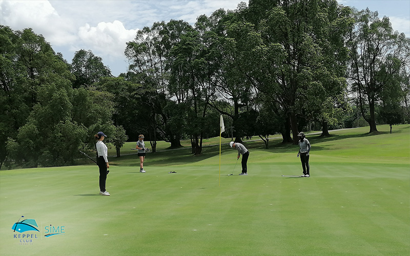 A couple of golfers practising their strokes